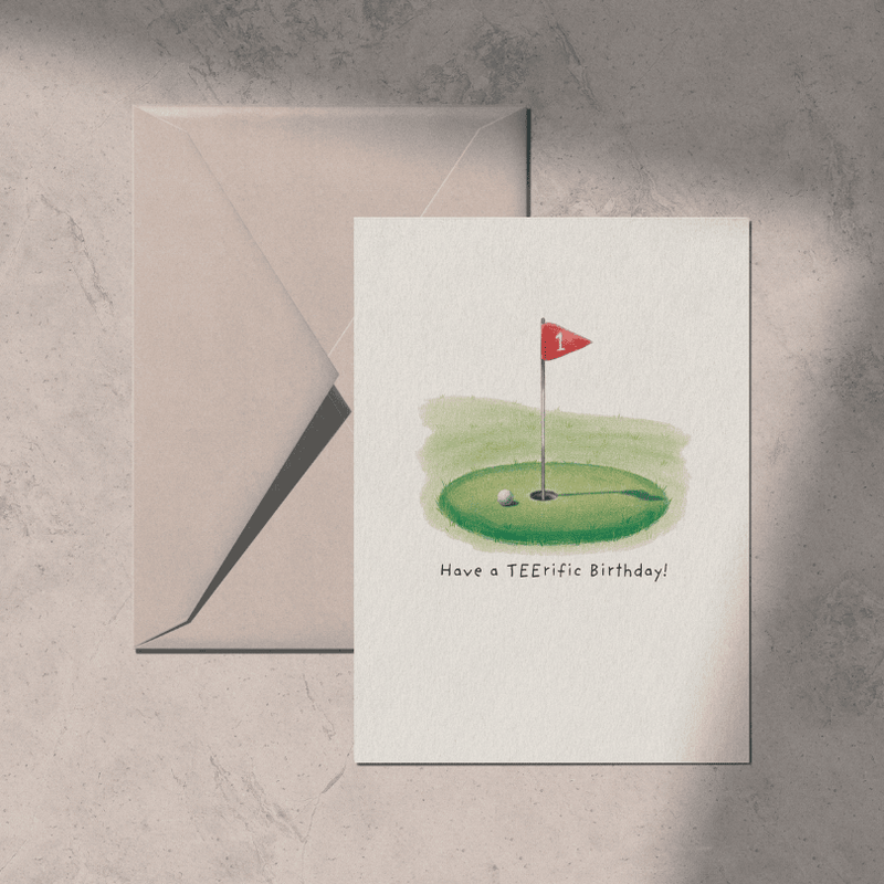 Greeting card with golf design and 'Have a TEERIFIC Birthday!' text, accompanied by an envelope on a textured surface golf theme gift for boyfriend